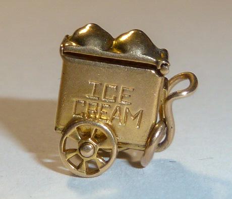 14kt Ice Cream Wagon 3D Movable Articulate Charm: Rolling ice cream cart has a lift up top , reveals a etched heart and lucky clover . The lucky clover leaves are said to stand for faith, hope and love the fourth stands for luck. Measures 1/2” 