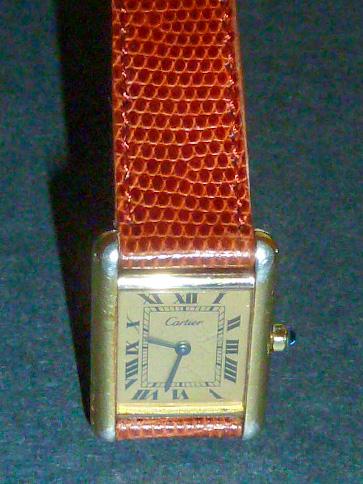 Cartier Paris Silver Tank Quartz Wrist Watch: Hallmarks on back of case, Cartier Paris , Tank Quartz, Swiss made.Sterling silver, Argent. Genuine Lizard Tourneau band.On the numeral X (Ten) Cartier name is spelled out, as it should be. As found e