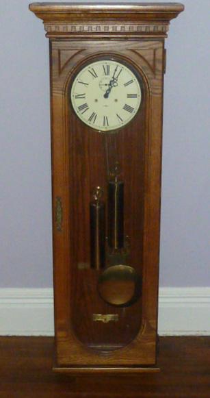 Howard Miller Key Wind w/ 2 Weights Oak Regulator Clock: Howard Miller No. 137 Gong Strike Cable Driven Movement.Large Oak Howard Miller Regulator wall clock. Model no. 612-485. Measures 54" Tall by 18 3/8" wide and 8 1/4" deep. Running but not guaranteed t