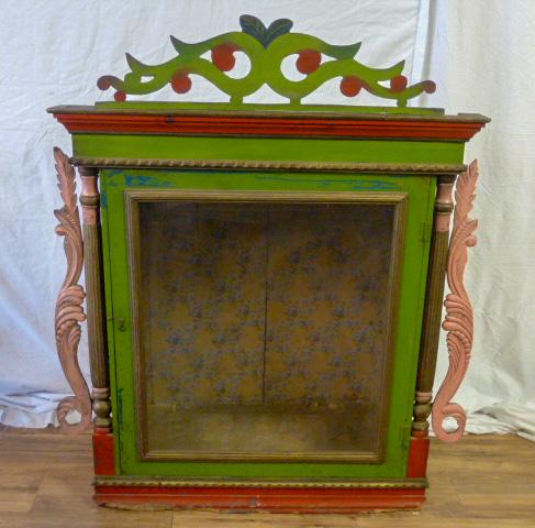 Folk Art Cabinet Ornate Cut-Out Scroll Top: Folk art cabinet in green and red with ornate cut-out scroll top moulding. Glass door with wallpaper interior. Measures . As found estate condition . Please use photos as part of the description. The 