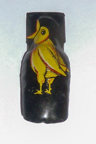 1930's Lithograph Black Metal Halloween Screaming Bird Clicker: 1930's Halloween Metal Screaming Bird Clicker in bright yellow and red on black painted metal. Signed German across front under paint .Measures 1 3/4" high by 3/4" wide. Pristine paint. As found estat