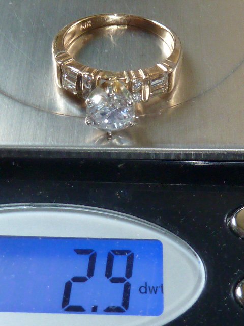 1 PLUS CARAT DIAMOND ENGAGEMENT RING: SHOWING A DIAMOND ENGAGEMENT RING WITH CENTER A CENTER DIAMOND THAT IS APPROX. 1.20 CARAT PLUS SIDE DIAMOND BAGUETTES.EXCELLENT AS FOUND ESTATE CONDITION.