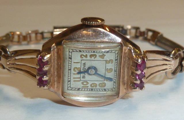 14KT GOLD & RUBIES BULOVA LADIES WATCH: SHOWING A 14KT GOLD AND RUBIES BULOVA LADIES WRISTWATCH . THE ABSENCE OF A CONDITION REPORT DOES NOT GUARANTEE EXCELLENT CONDITION.PLEASE CONTACT US FOR AN IN HAND EVALUATION OR ADDITIONAL PHOTOS IF Y