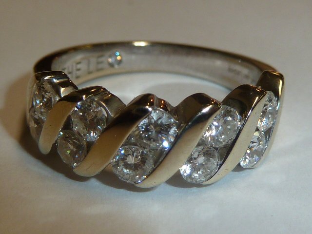 THE LEO 14KT GOLD RING DOUBLE ROW OF DIAMONDS: SHOWING A 14KT YELLOW GOLD RING WITH TEN DIAMONDS SET IN A DOUBLE ROW . THIS IS A LEO RING , MADE BY MASTER JEWELRY DESIGNER LEO SCHACHTER . SIZE 6 3/4 . THE ABSENCE OF A CONDITION REPORT DOES NOT GUA