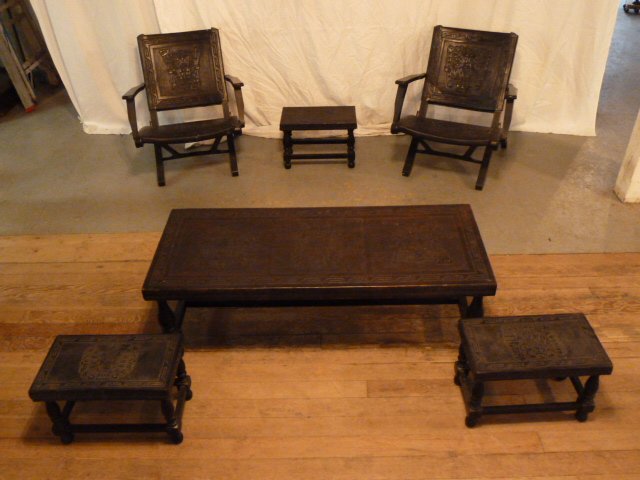 6 PIECE HAND TOOLED LEATHER SET AZTEC MOTIF: SHOWING AN EXCEPTIONAL SIX PIECE HAND TOOLED LEATHER RUSTIC FURNITURE , AZTEC MOTIF ON ALL SURFACES . THREE SMALL STOOLS 18" X 10" X 12 1/2" , COFFEE TABLE 50" X 20" X 16" , TWO FOLDING CHAIRS 29" X 2