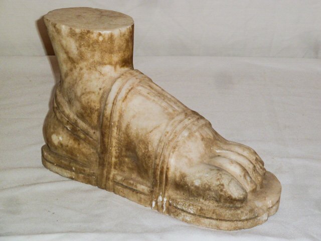 HAND CARVED MARBLE SCULPTURE OF A ROMAN FOOT: SHOWING A HAND CARVED MARBLE SCULPTURE OF A HUGE ROMAN FOOT WEARING A SANDAL . MEASURES 14" LONG BY 8 1/2" HIGH AND 5" DEEP. AS FOUND ESTATE CONDITION.PLEASE USE PHOTOS AS PART OF THE DESCRIPTION. THE