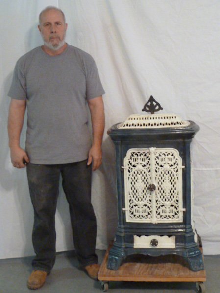 C1900 ORNATE PORCELAIN OVER CAST IRON WOOD STOVE: SHOWING A CIRCA 1900'S ORNATE PORCELAIN OVER CAST IRON WOOD STOVE ORIGINAL COLOR ON EMBOSSED FEET . MEASURES 23" WIDE BY 42" HIGH AND 16" DEEP. AS FOUND ESTATE CONDITION.PLEASE USE PHOTOS AS PART OF T
