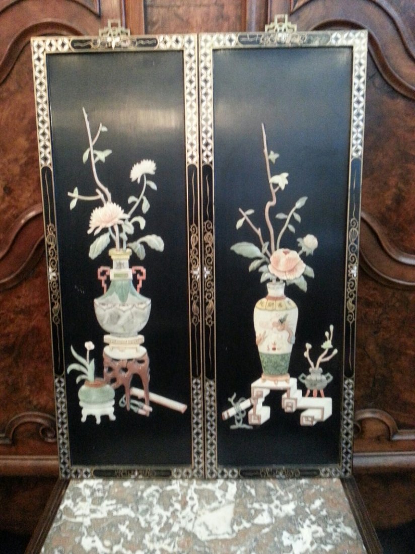 Pair Chinese lacquer plaques: Pair of 20th c. Chinese lacquer plaques with mother of pearl and semi-precious stone inlay work in the form of vases, flowers, tables, scrolls, and gilt design on frame. Each Panel measures 34 X 12