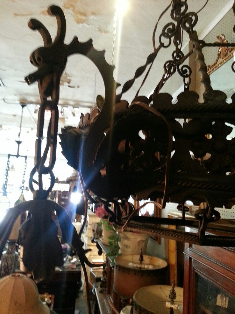 Brown dragon iron chandelier: Large brown iron dragon chandelier with design of crosses, Nordic dragon heads, and flowers.28" Diam X 35" HT, electrified