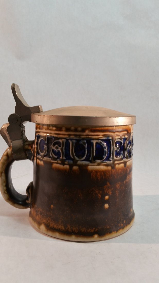 Beer stein: Vintage German earthenware beer stein with pewter lid.