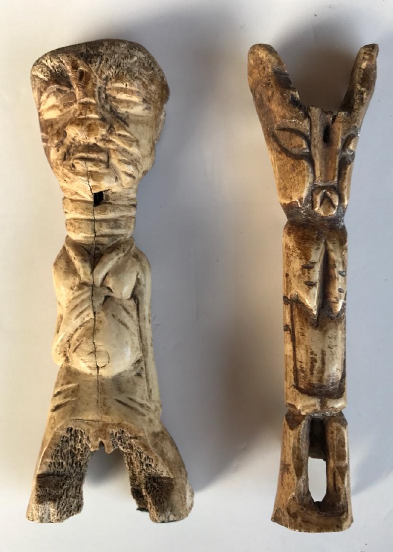 Early Primitive Figural Guardian Bone Carvings (2): Two antique hand-carved figural ancestral bone carvings. Dimension: 6.25"hgt. x 2"wd (approx.). Condition: very good estate condition, age appropriate. Provenance: Originally acquired during the 1940'