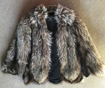 Silver Fox Swing Fur Coat: Silver Fox Fur Stroller Coat. Interior label: "Abraham & Strauss Fine Furs". Cape like flowing swing fur coat. Long hair fur. Size 6-8. 2 Deep pockets, 3 clip closure. Silk lined. Approximate measurem