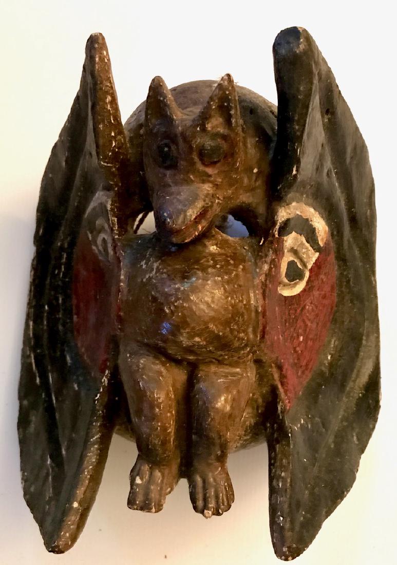 Early African Ceremonial Carved Spirit Deity Mask: Antique carved and painted wood mask with center deity figure. Dimension: 10"lgt. x 10"wd. x 7"dp.. Mask face with an emerging fully carved body of an animal deity with horns. Condition: good conditio