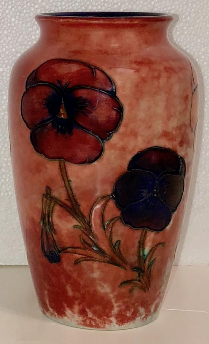 Moorcroft PANSY VASE: Moorcroft Pansy Vase, circa: 1930. This is a high-shouldered tapering cylindrical body with a slight everted rim. Vase is painted in orange, cobalt, green and purple on a mottled pale red ground. Blue