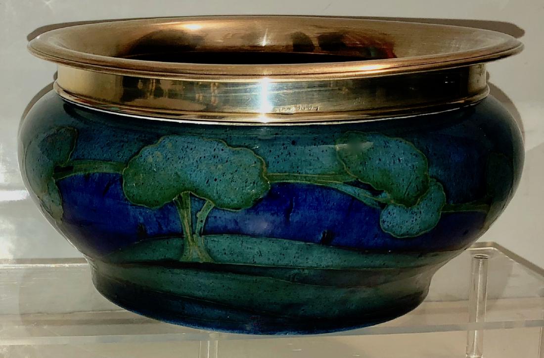 Moorcroft Moonlit Blue Landscape Sterling-Mounted Bowl: Moorcroft Moonlit Blue Landscape sterling silver-mounted bowl. Circa: 1925. Circular baluster form with slight everted silver-mounted rim above a wooded landscape scene. Scene is painted in green, yel