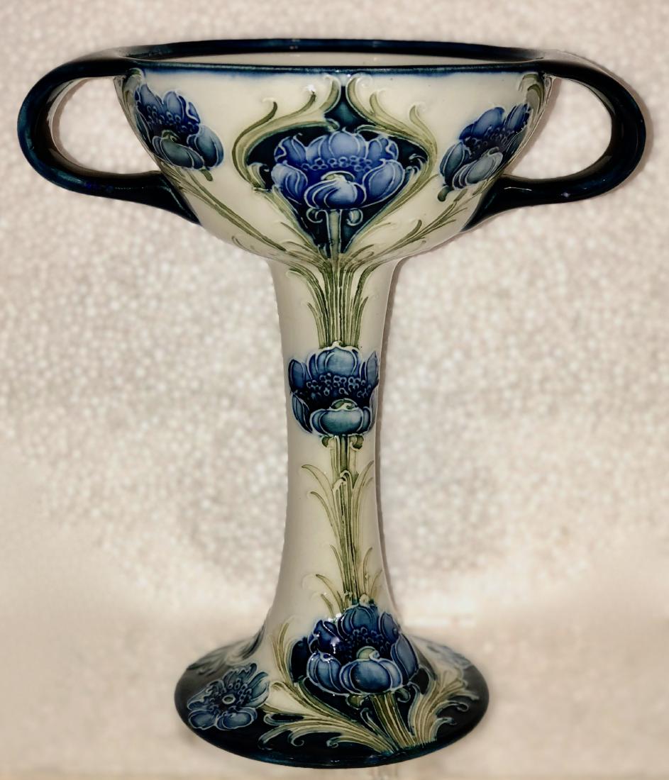 Moorcroft Florian Ware Macintyre Twin-Handled Cup: Moorcroft Florian Ware Macintyre Poppy pattern twin-handled cup / chalice. Circa 1903. Shallow bowl with strap handles above a long stem on circular foot. Tall chalice cup is painted in cobalt, green,