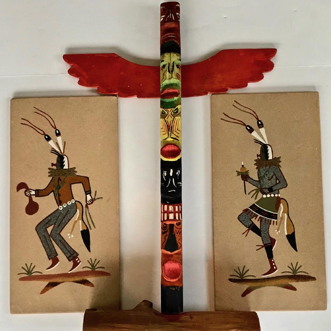 Native American Indian Totem & Sand Paintings (2): Three vintage Native American Indian items. Folk art carved and painted totem pole. Dimensions: 24 in. x 16 in. (2) Sand paintings signed and titled by the artist on verso. Dimensions: 16 in. x 8 in. 
