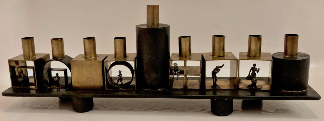 Modernist Sterling, Copper & Brass Menorah Chanukiah: Modernist handmade figural sterling, copper and brass chanukiah signed by the artists MASO & JMO. Dimensions: 4 1/8 in. hgt. x 12 in. wd. x 2 in. dp. Menorah features a modernist industrial figural de