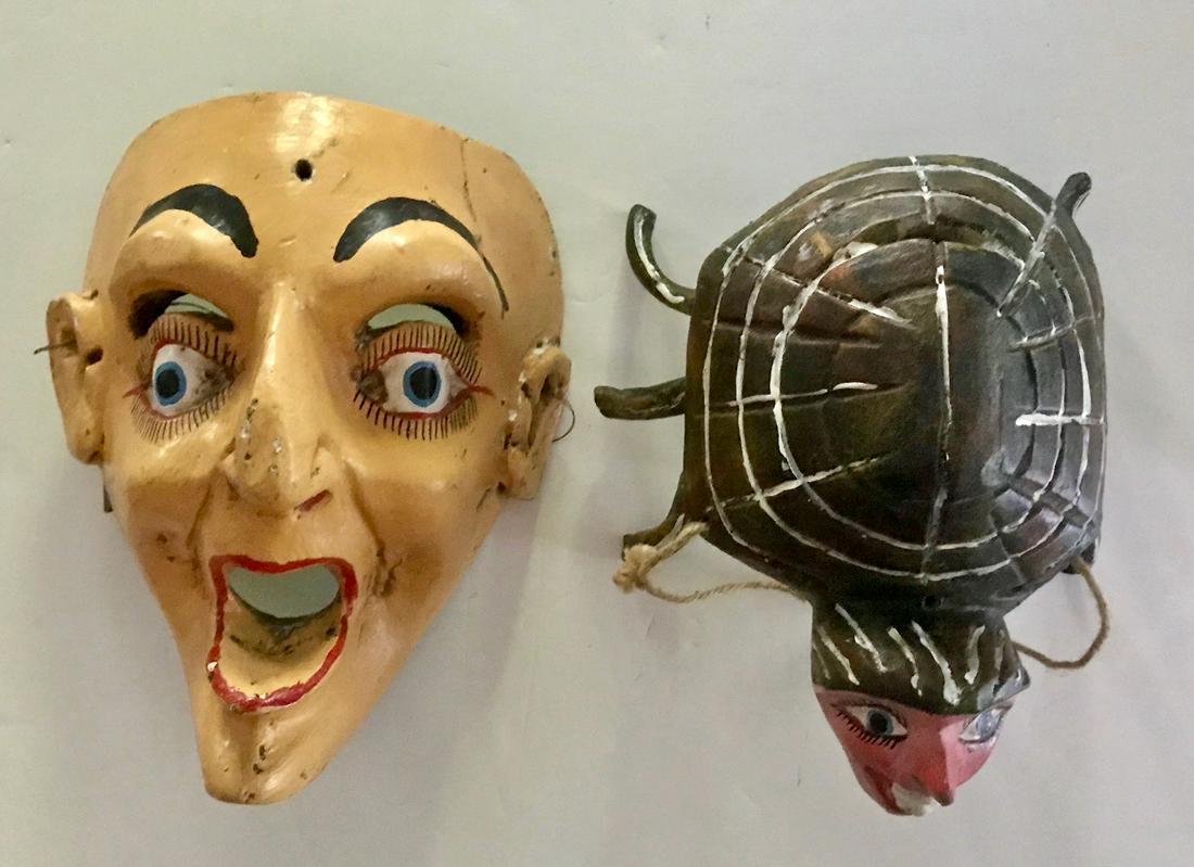 Two Mexican Cinco de Mayo Carved Folk Art Masks: Two vintage hand-carved and painted Mexican folk art festival masks. 1) Cinco de Mayo Face mask. Dimensions: H: 11 in., W: 9 in., D: 5 in. 2) Human Insect Mask. Dimensions: L: 10 in., W: 9 in., D: 5 i