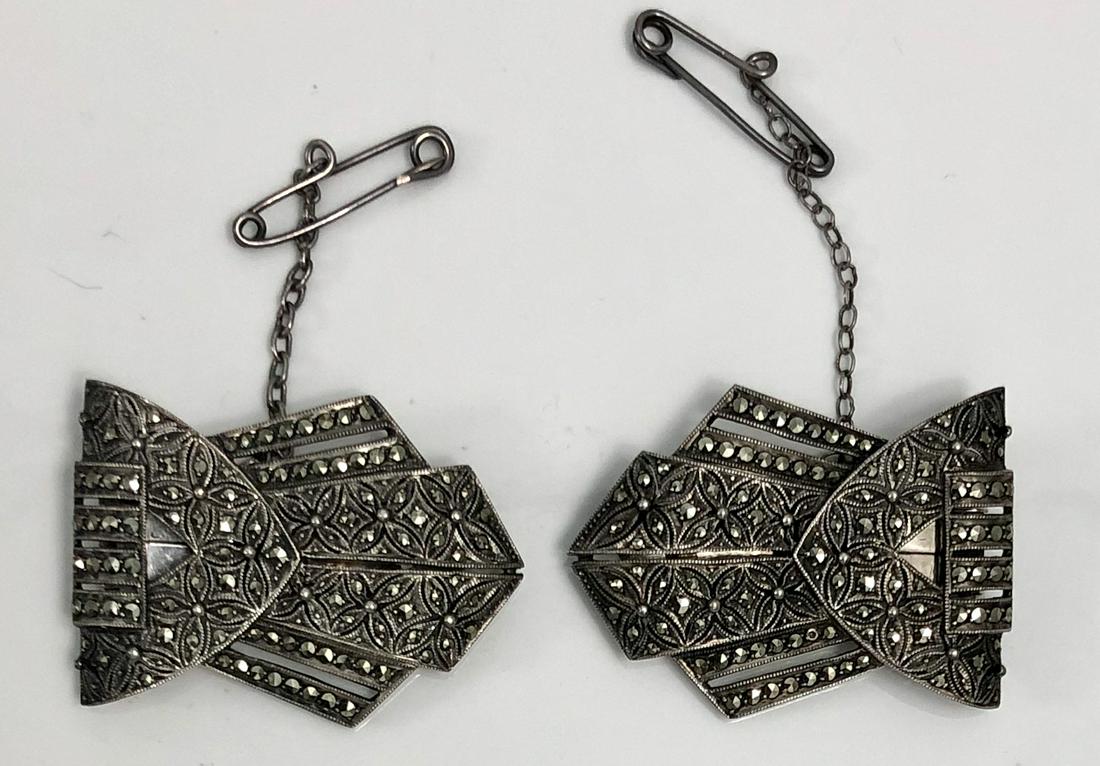 Art Deco Sterling Silver Marcasite Dress Clips-Brooch: Pair of German sterling silver Dress Clips-Brooch set with marcasites. Clips are both marked: Sterling Germany. Approximate weight: 19.64 grams. Dimensions: H: 1 3/8 in. x 1 in. Condition: good origin