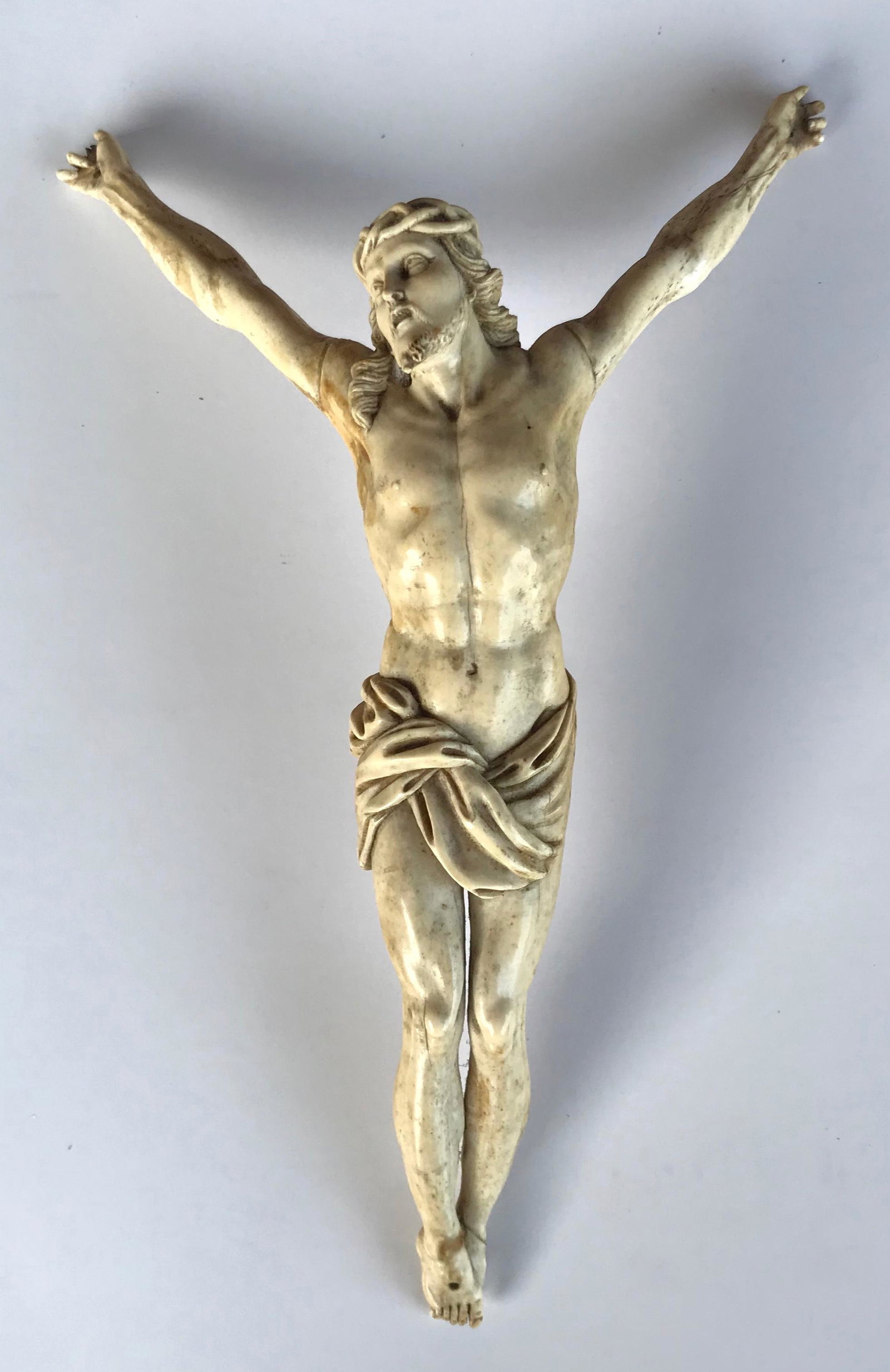 Antique European Carved Bone Corpus Christi Figure: Early antique European hand-carved bone figure depicting Corpus Christi. 19th century (possibly earlier). Dimensions: Height (with outstretched arms): 10 in., W: 6 1/4 in., Height (without outstretche