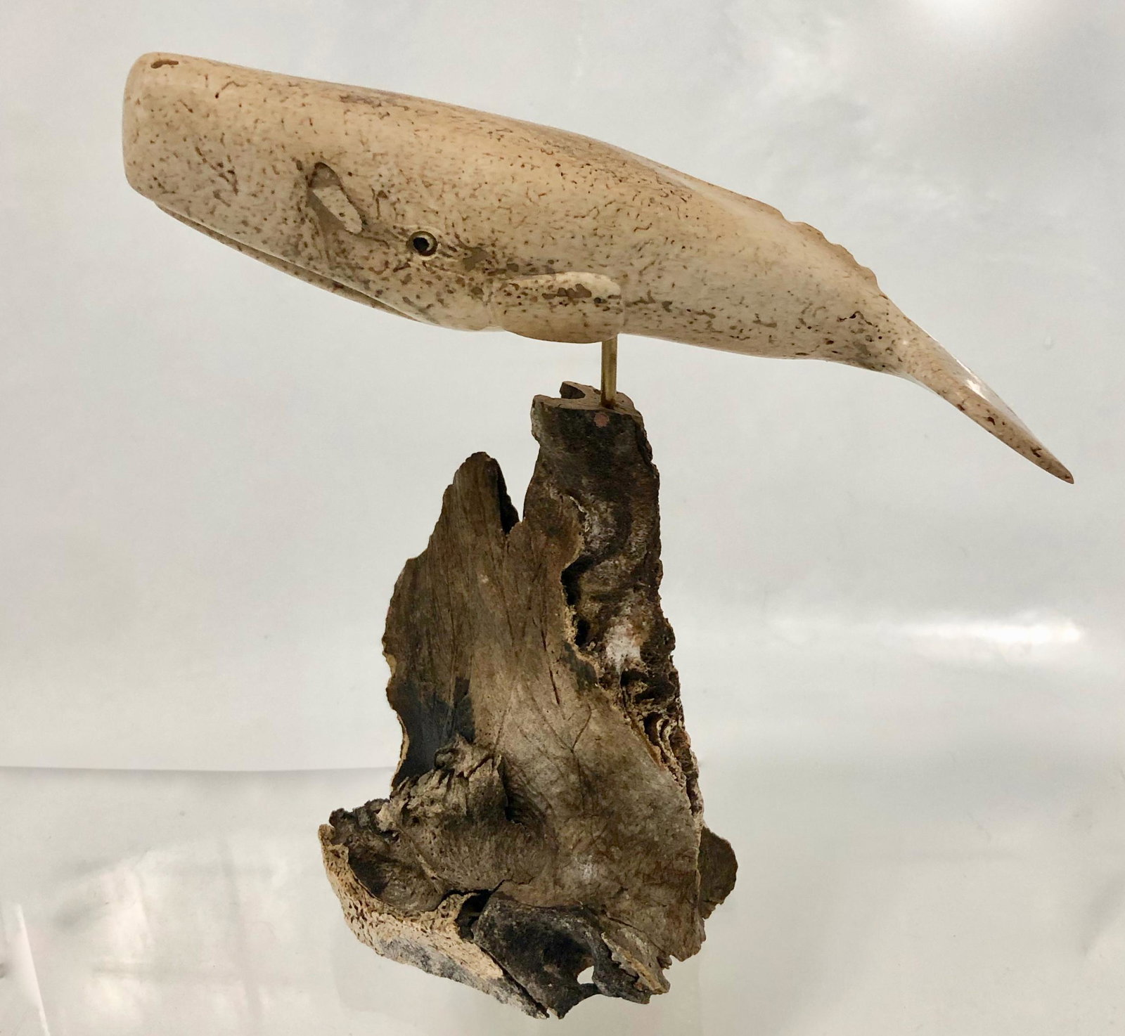 Fossil Whale Bone Carving George Vukson, Alaska: Vintage Alaskan fossil whale bone-carving, signed by the artist, George Vukson (Russian/American, 20th century). Hand-carved and signed on fin, Vukson. Dimensions: Height of bone with mount: 7 1/2 in.