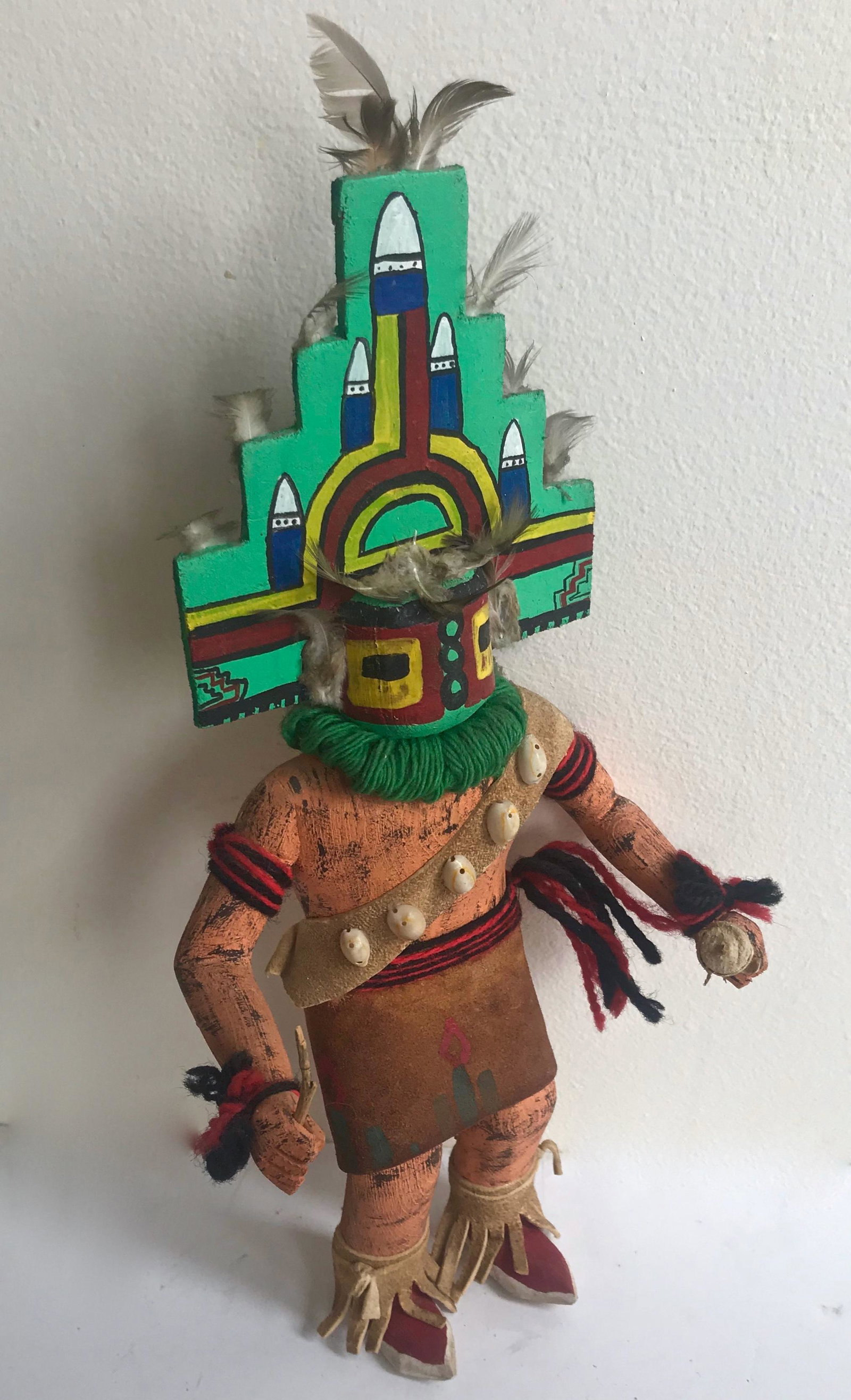 Native American Hopi HEMIS Kachina Doll: Hopi Native American Carved Katsina Doll. Hand-carved and painted cottonwood decorated with feather, shells and leather. Carved from a single piece of wood. Flat back. Circa 1960. Dimensions: H: 13 in