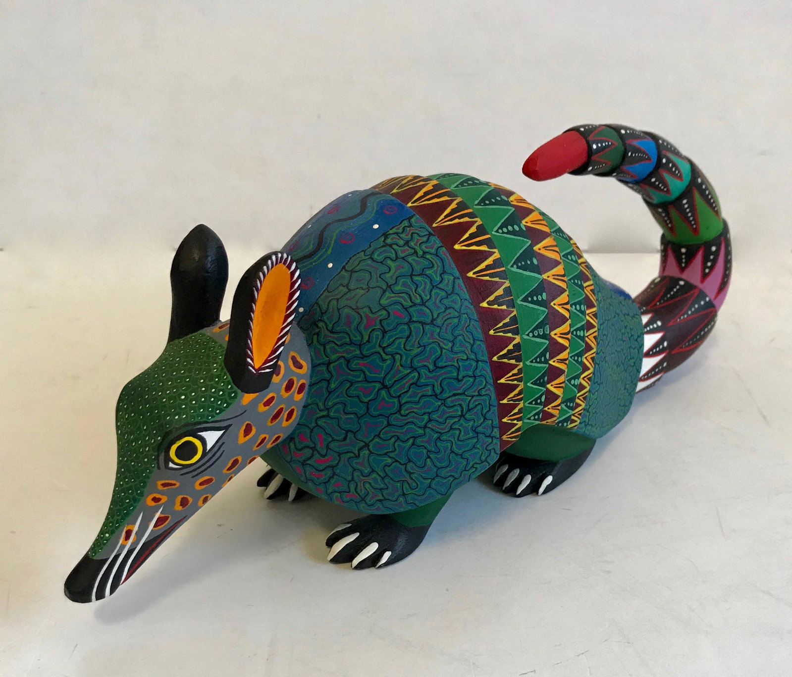 Oaxacan Alebrijes Carved ARMADILLO Castellanos: Folk artist master carvers, Mario & Reina Castellanos Oaxacan,Mexico, hand-carved and painted ARMADILLO. Carved from a solid piece of copal wood. Signed on underside, Mario Castellanos and Reina Gonza