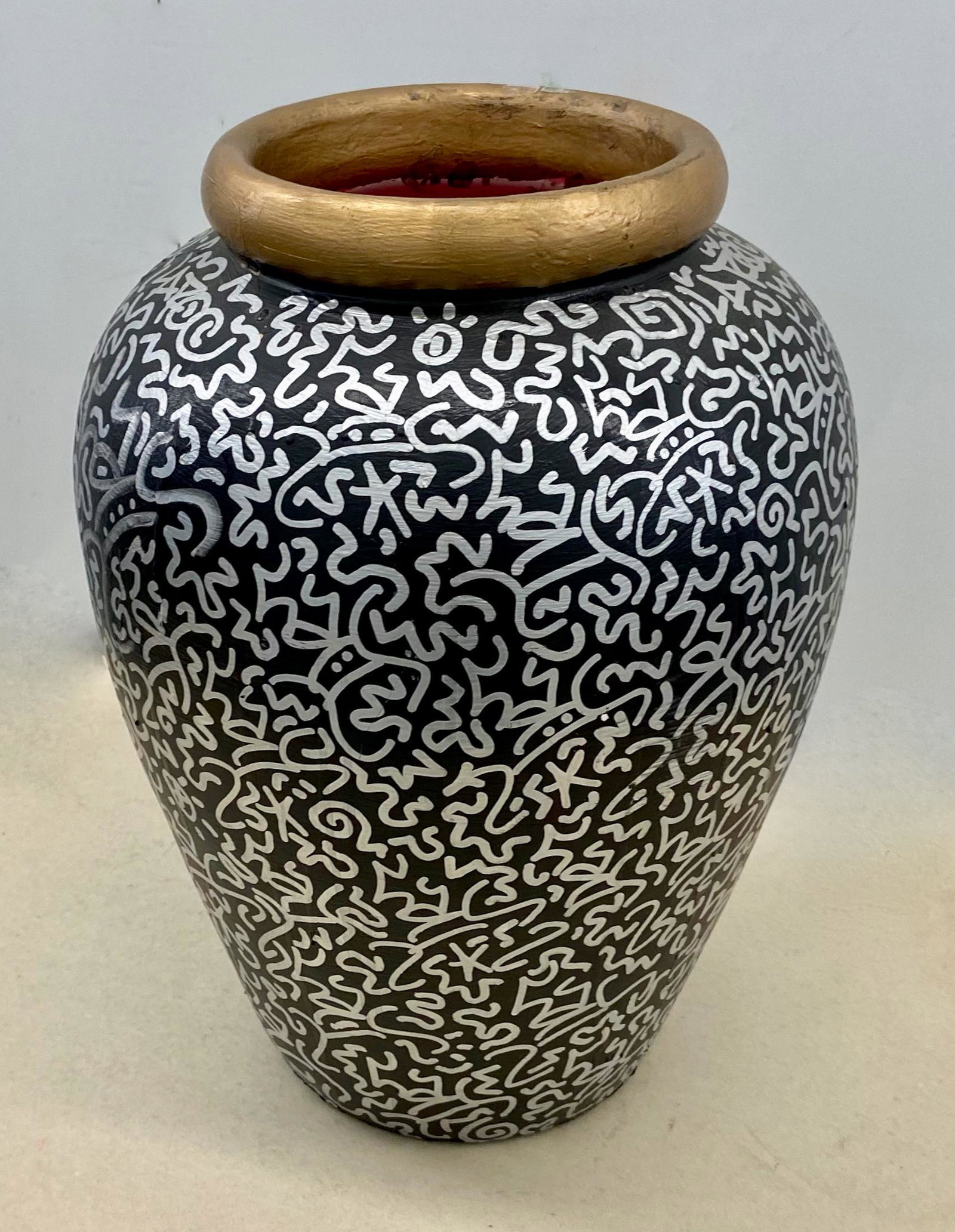 LA II Urban Graffiti Painted Vase Tagged Throughout: LA II (Angel Ortiz) urban graffiti painted pottery vase tagged throughout. Pottery vase with acrylic black paint foundation, gold paint rim then tagged with silver metallic paint marker. Circa 1990s, 