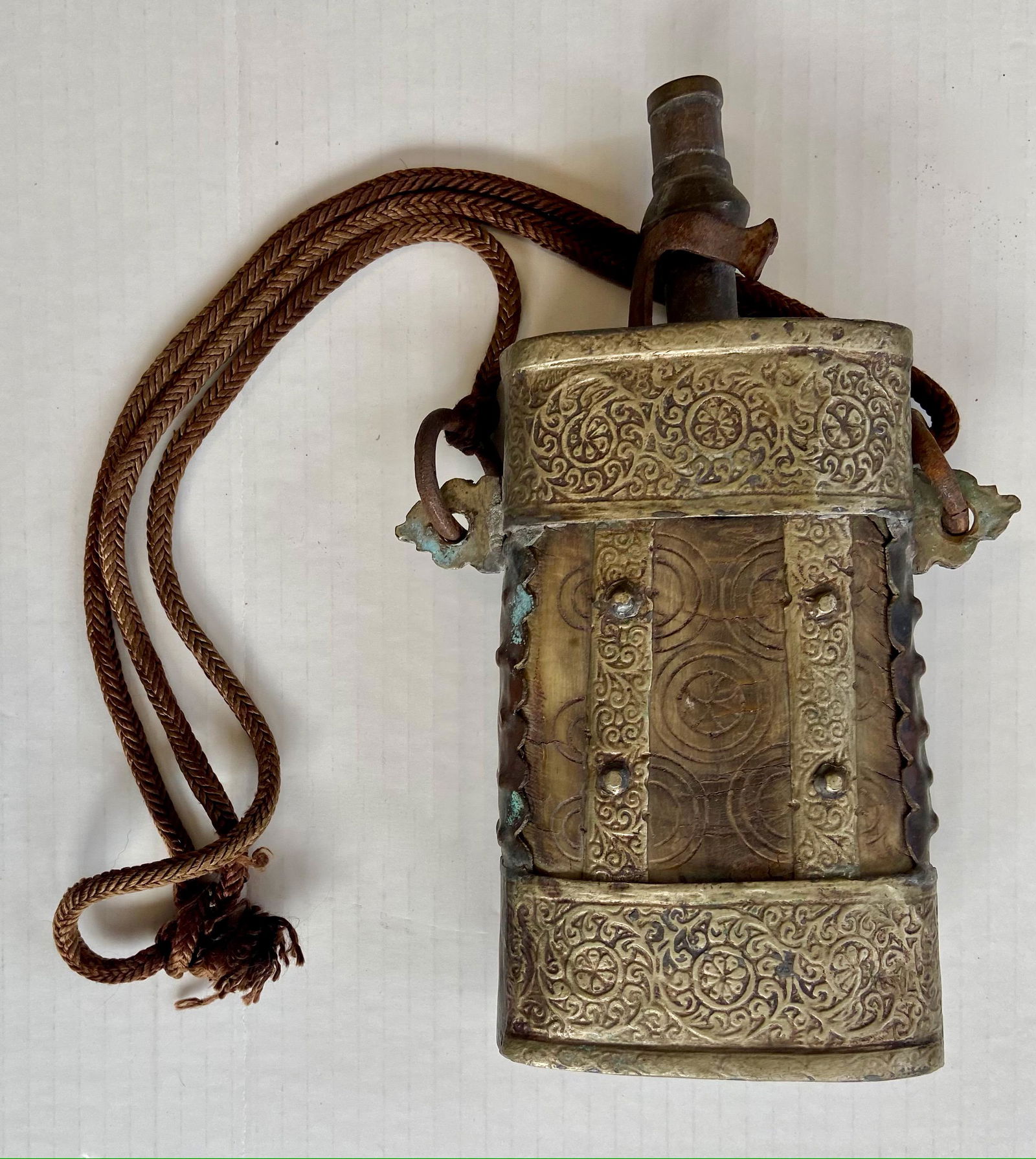Antique Ottoman Islamic Tribal Gun Powder Horn Flask: Middle Eastern tribal antique gun powder horn flask. Late 1800s. Animal horn with carved circular designs and a hammered copper intricate embossed surround, including a braided side rope. Dimensions: