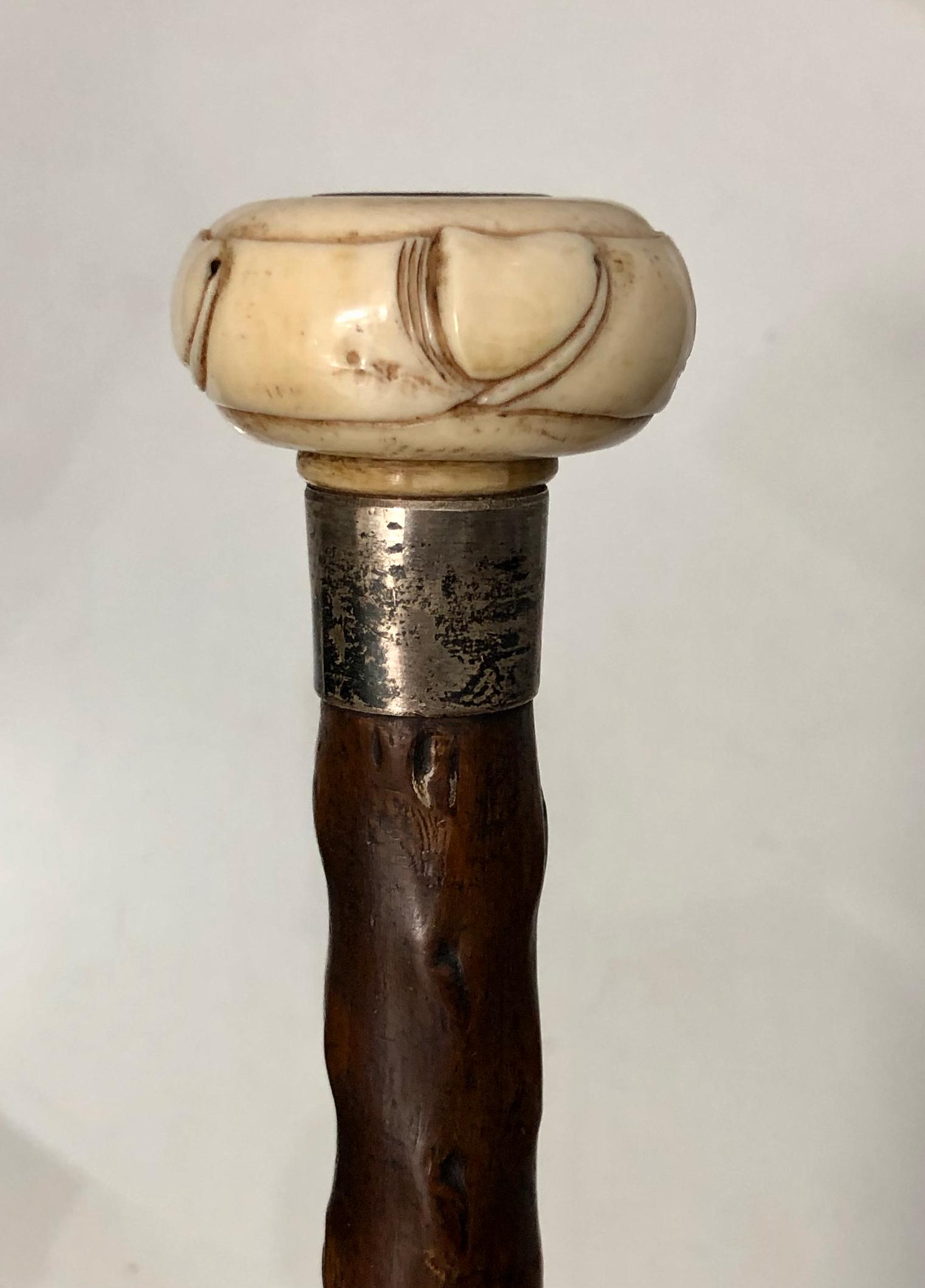 Erotic Phallic Carved Bone Handle Walking Stick: Erotic carved bone phallic handle wood walking cane. Multiple phallic images carved on the bone handle (view photo). Early 20th Century. Dimension: wood cane: Length: 32 inches. Bone Handle: Diameter:
