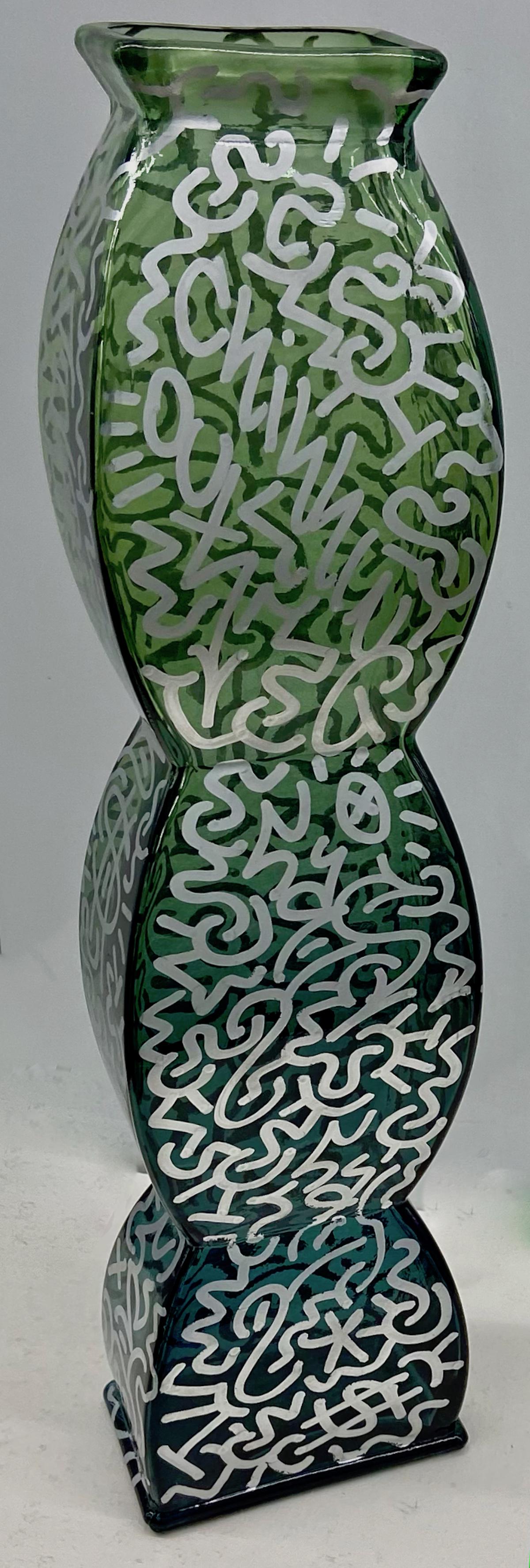 LA II (Angel Ortiz,1966) Graffiti Vase CHILLIN: Urban graffiti painted vase tagged throughout by the artist LA2 (Little Angel). Metallic silver paint marker on tall greenish cased shape glass.Dimensions: H: 21 7/8 in., W: 5 1/2 in., D: 3 1/2 in. Co