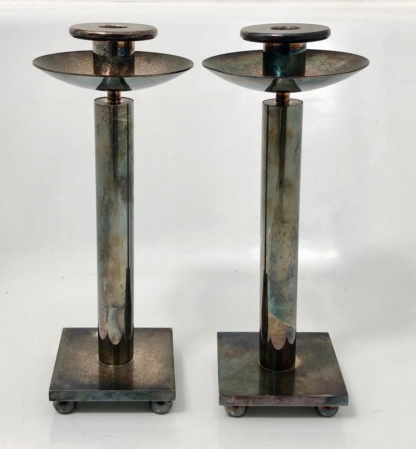 Italian Postmodern Candlesticks By Richard Meier For Swid Powell, 1980s: Pair of Italian Swid Powell silverplate candlesticks designed by architect Richard Meier. Stamped on bottom: Swid Powell RM Made In Italy Silverplated (view photo). Dimensions: Height: 12 in., Width: