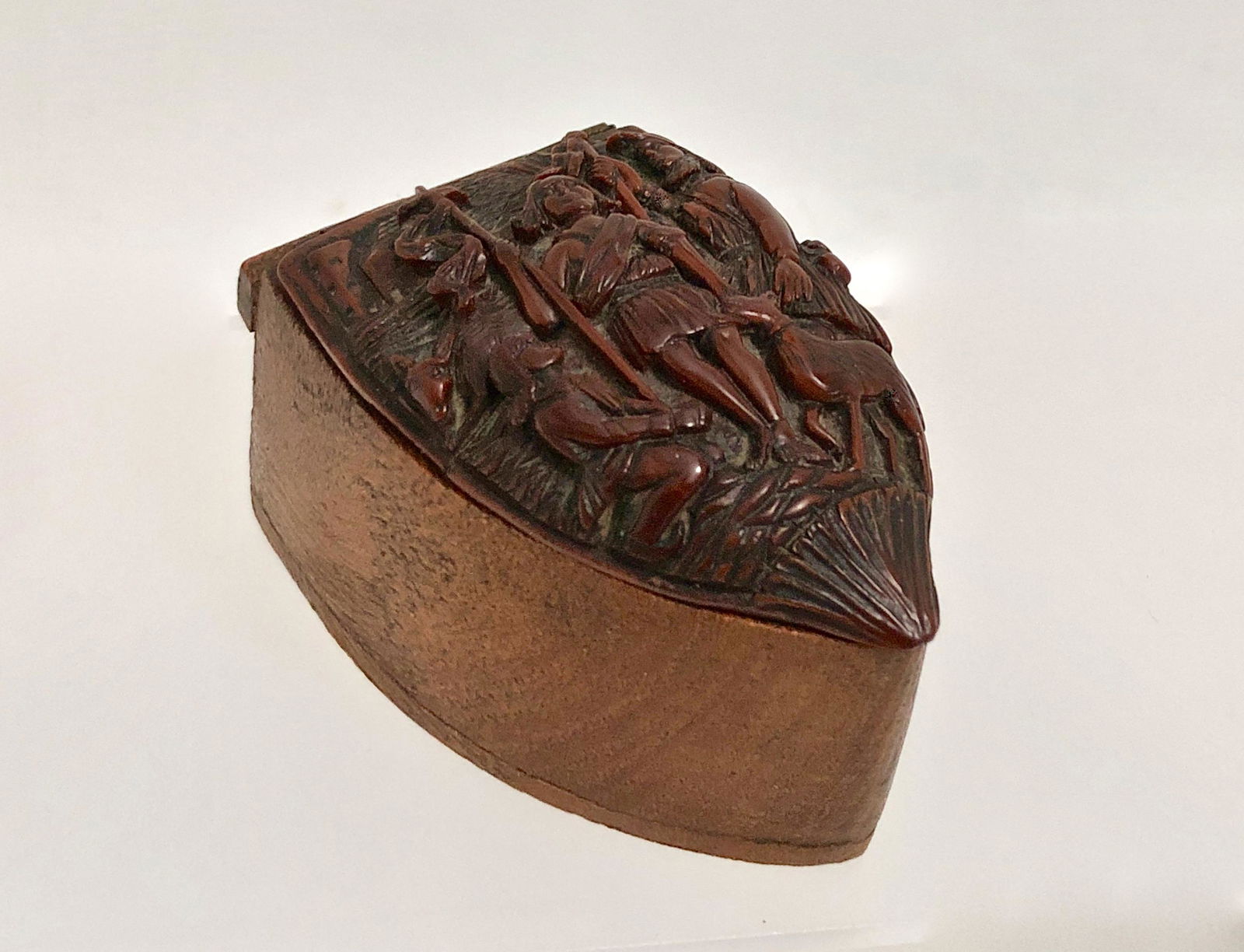 18th Century Carved Figural Tobacco Snuff Box: 18th century carved coquille nut shield shape snuff box, with a finely hand-carved figural religious scene on lid. Coquille shell with softwood base and hinged top. Dimensions: length: 2 1/2 in., heig