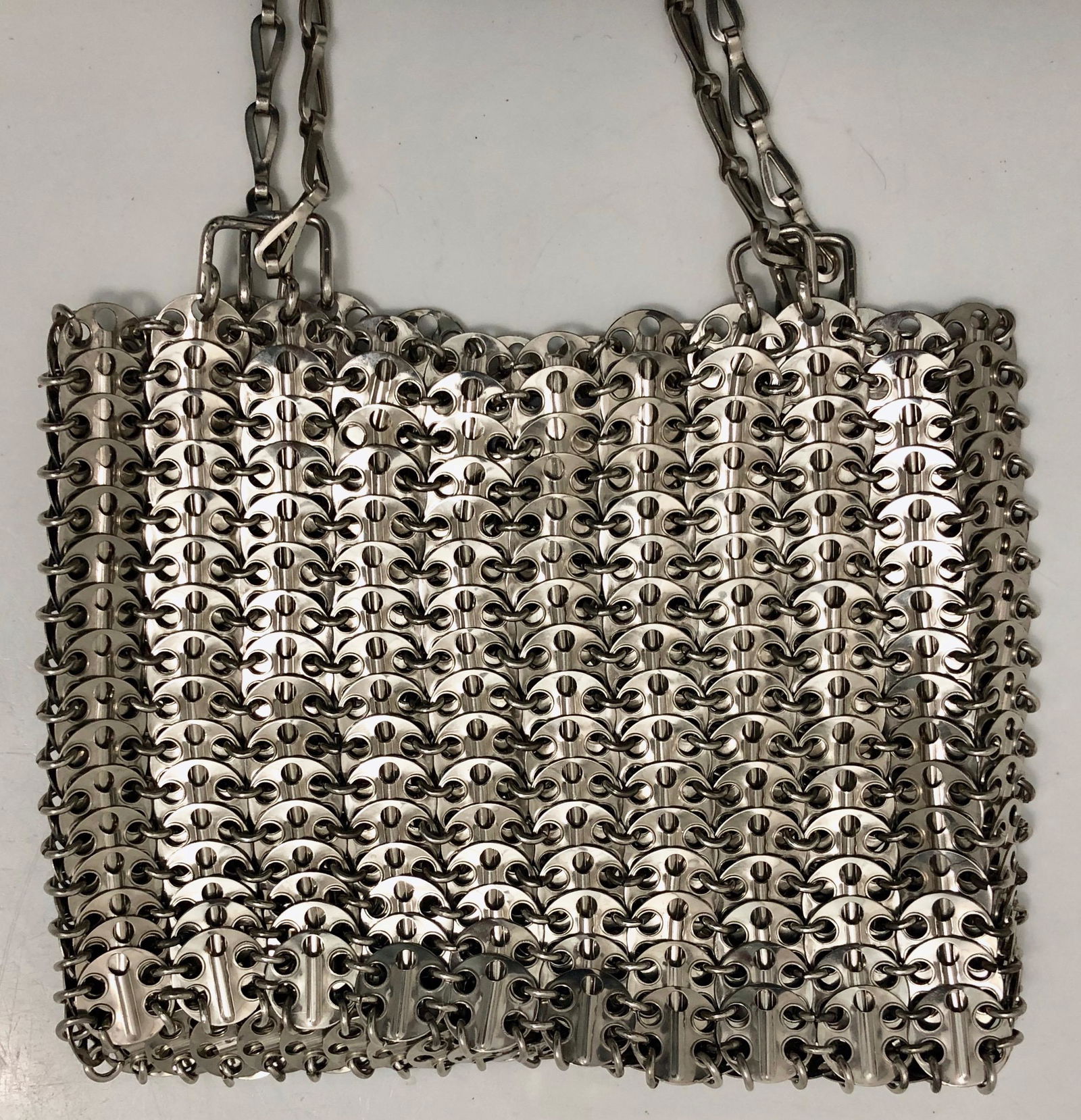 PACO RABANNE Chainmail Disk-Embellished Shoulder Bag, 1969: Original PACO RABANNE chainmail disc-embellished silver-tone metal shoulder bag. Adjustable shoulder strap. Crafted with an all-metal disc structure. Attached label reads: paco rabanne, paris Made in