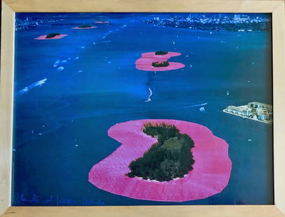 Christo (1935-2020) Jeanne-Claude (1935-2009) SURROUNDED ISLANDS, Hand-Signed: Surrounded Islands, Biscayne Bay, Miami, 1983. Photographic offset lithograph hand-signed in blue crayon by the artists, Christo and Jeanne-Claude (lower left). Dimensions: framed: 28 in. x 35 3/4 in.