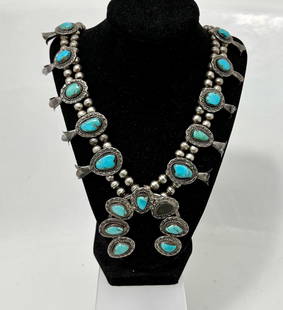 Navajo Old Pawn Turquoise Sterling Silver Squash Blossom Necklace, Signed: Antique Navajo Old Pawn Turquoise Sterling Silver Squash Blossom Necklace, signed by the Silversmith. Ten squash blossoms flank a naja pendant with seven surrounding turquoise stones. Artist stamped H