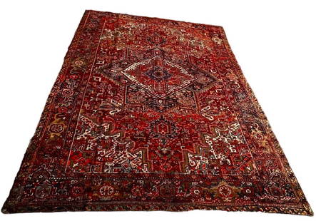 Semi-Antique Handwoven Persian Heriz Rug 12 feet x 9 feet: Estate Semi-Antique Hand knotted Persian Heriz Wool Rug. Striking colors and designs created around a central medallion motif. Original Iran label attached on reverse. Approximate dimensions: length:
