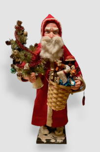 German Belsnickle Santa Claus Candy Container: 20 inches: German Belsnickle Composition Santa Claus Candy Container holding Basket of Toys and a Feather Tree. Cardboard tube and composition Santa Claus with deep blue eyes looking up from his hood covered hea