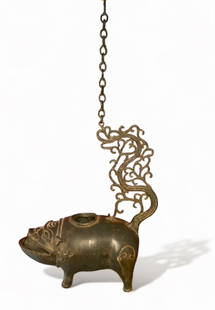 Antique Javanese Bronze Boar Hanging Oil Lamp: Antique Hanging Java, Indonesian Bronze Boar Form Oil Lamp. Bronze Boar with etched and applied archaic designs. The scrolling tail curling upwards is suspended by a chain and hook. Approximate dimens