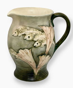 William Moorcroft Matte Glaze Fish Pitcher Jug, Circa 1930s: William Moorcroft matte glaze fish pattern jug of baluster form, circa 1930s.Body decorated with three fish swimming amongst foliage and water lilies. Pitcher jug has a strap handle and incised