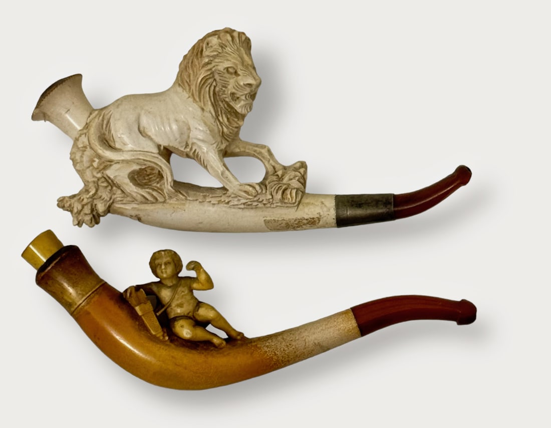 19th C. Antique Carved Lion & Cupid Meerschaum Smoking Pipes: Antique 19th Century Hand-Carved Meerschaum Pipes With Amber Stems. 1) Fine carved standing lion. 2) Intricately carved reclining cupid figure. Condition: good original pre-owned estate condition, no