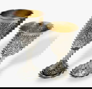 Judaica: Two Sterling Silver Kiddush Cups Includes Bezalel: Two Early Sterling Silver Kiddush Cups.1) Bezalel Kiddush Cup crafted in sterling silver adorned with acid etched grapevine design and applied filagree on stem (view photo).Stamped on underside: