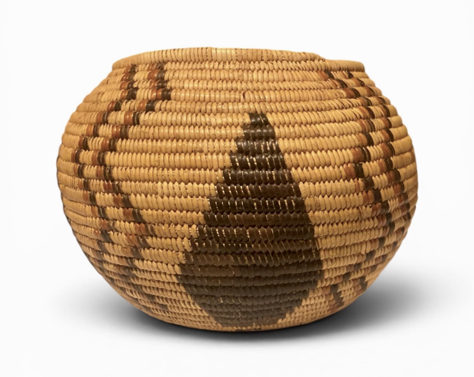 Native American Paiute Polychrome Globular Basket: Great Basin Region, Paiute Polychrome Woven Basket. Globular coiled, geometric woven designs with center diamond triangle and pair of double-sided zig-zag lines. Designs of symbolic Mountain Peak & Ra