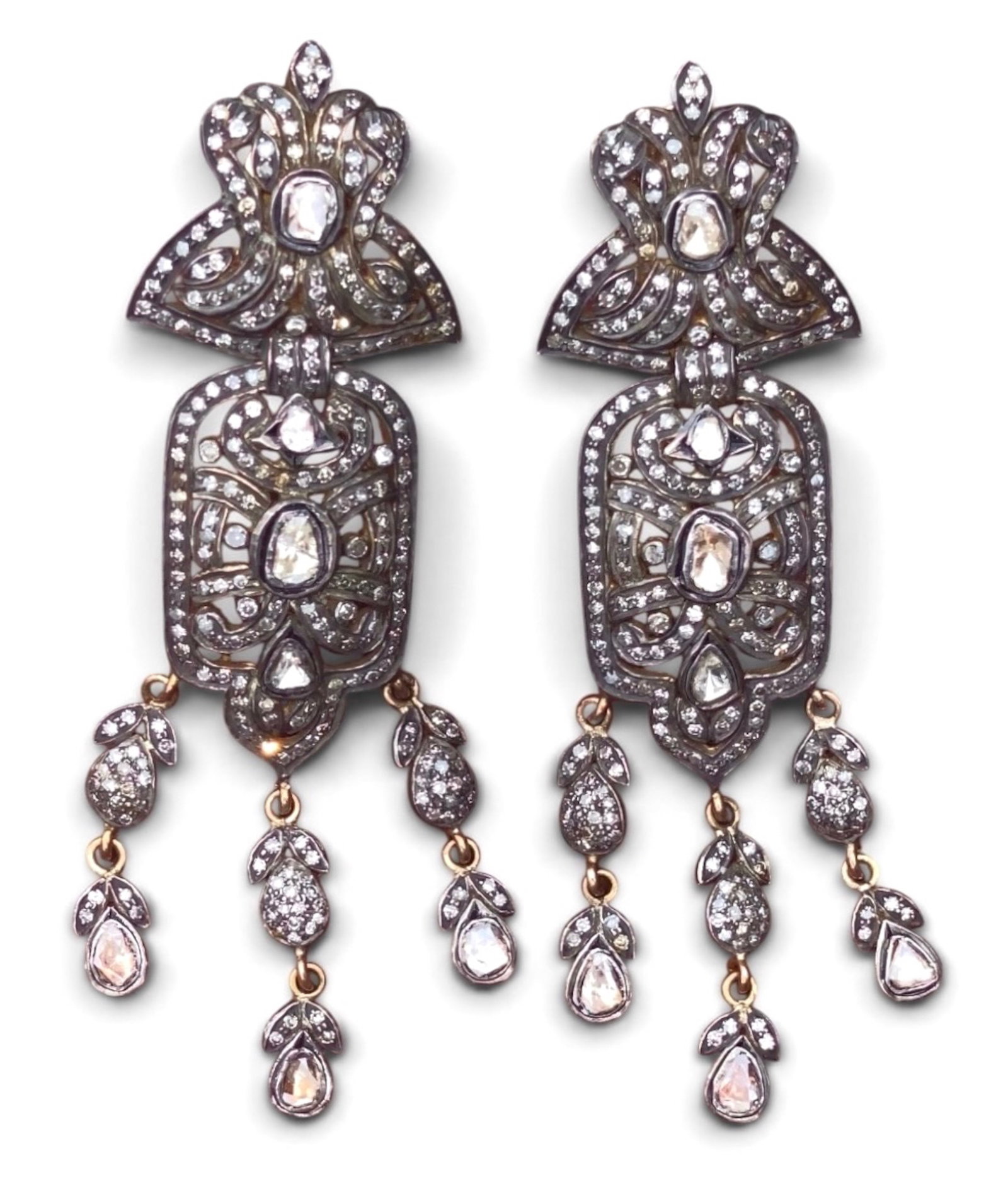 Pair Of Art Deco Mughal 18k Gold & Silver Diamond Chandelier Earrings: Pair of Art Deco Mughal 18k Gold and Silver Diamond Dangle Earrings. Handcrafted in 18 karat gold and sterling silver, hand set with rose-cut and flat-cut polki diamonds. Multi-tiered filigree with op
