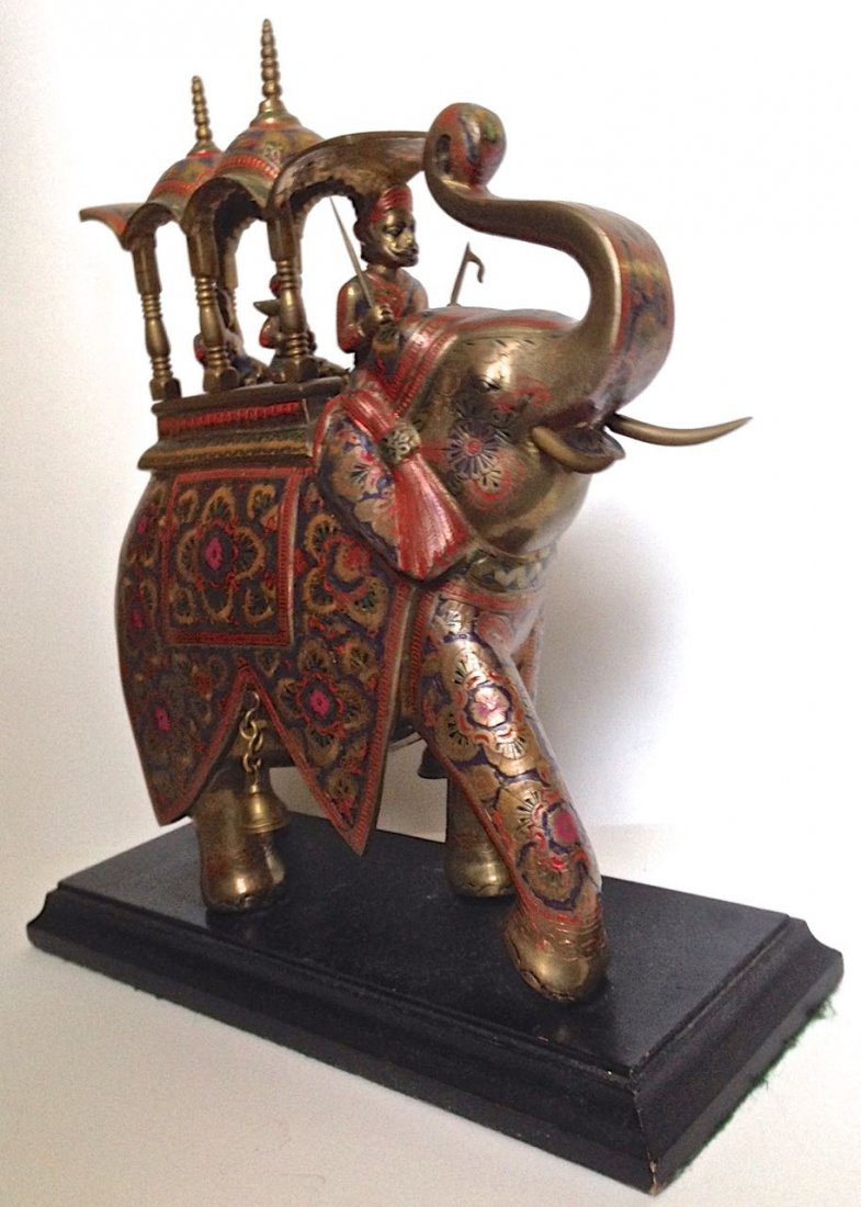 CEREMONIAL INDIAN ELEPHANT SCULPTURE ON WOOD PLATFORM: CEREMONIAL INDIA ELEPHANT SCULPTURE Elephant is standing on wood platform Image of ornate cold painted decorated elephant with Mughal figures Mixed metal, cold-painted Dimension: sculpture with stand 