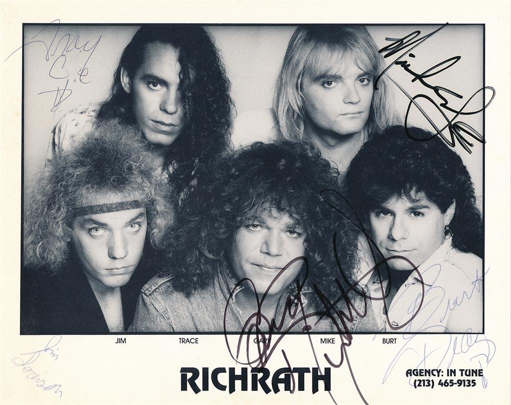 Richrath Signed Photograph "REO Speedwagon": Vintage 10x8 black and white photograph signed by all five members of Richrath with blue and black ink. Signed by Gary Richrath, Jim ?, Trace ?, Mike ? and Burt ?. In good condition.(1949â€“2015)
