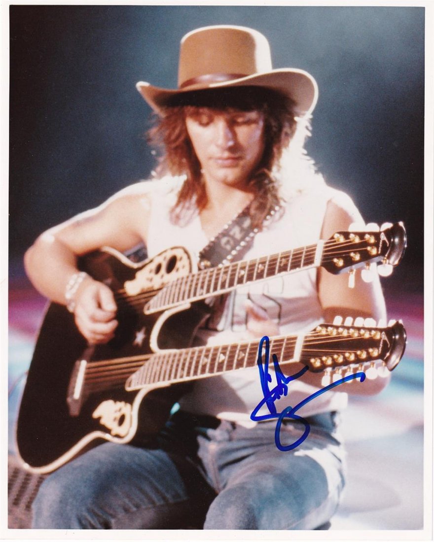 Richie Sambora-Signed Color Photograph: 8x10 Color glossy finish photograph signed in blue felt tip ink by Richie Sambora. In excellent condition. He is an American rock guitarist, singer, songwriter, and producer, best known as the lead gu