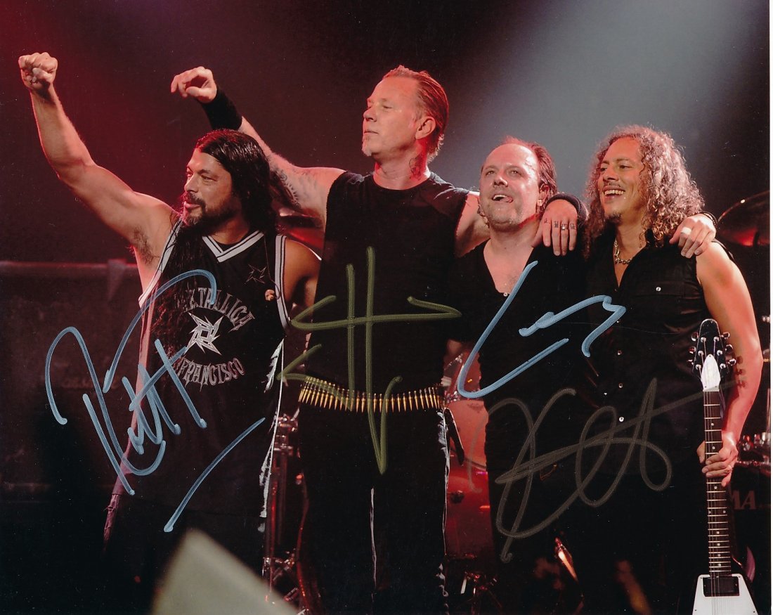 Metallica- Signed Photo by all 4 Band Members: 10x8 Color satin finish photograph of the band "Metallica," and signed in silver and gold inks by James Hetfield, Lars Ulrich, Kirk Hammett, and Robert Trujillo. Excellent condition. Comes with a full