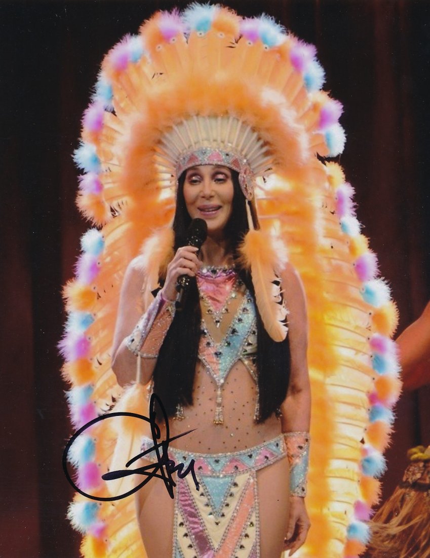 Cher-Signed Photograph: 8x10 Color satin finish photograph signed in black felt tip ink by Cher. Excellent condition. Comes with a full Letter of Authenticity from Todd Mueller Authentics.